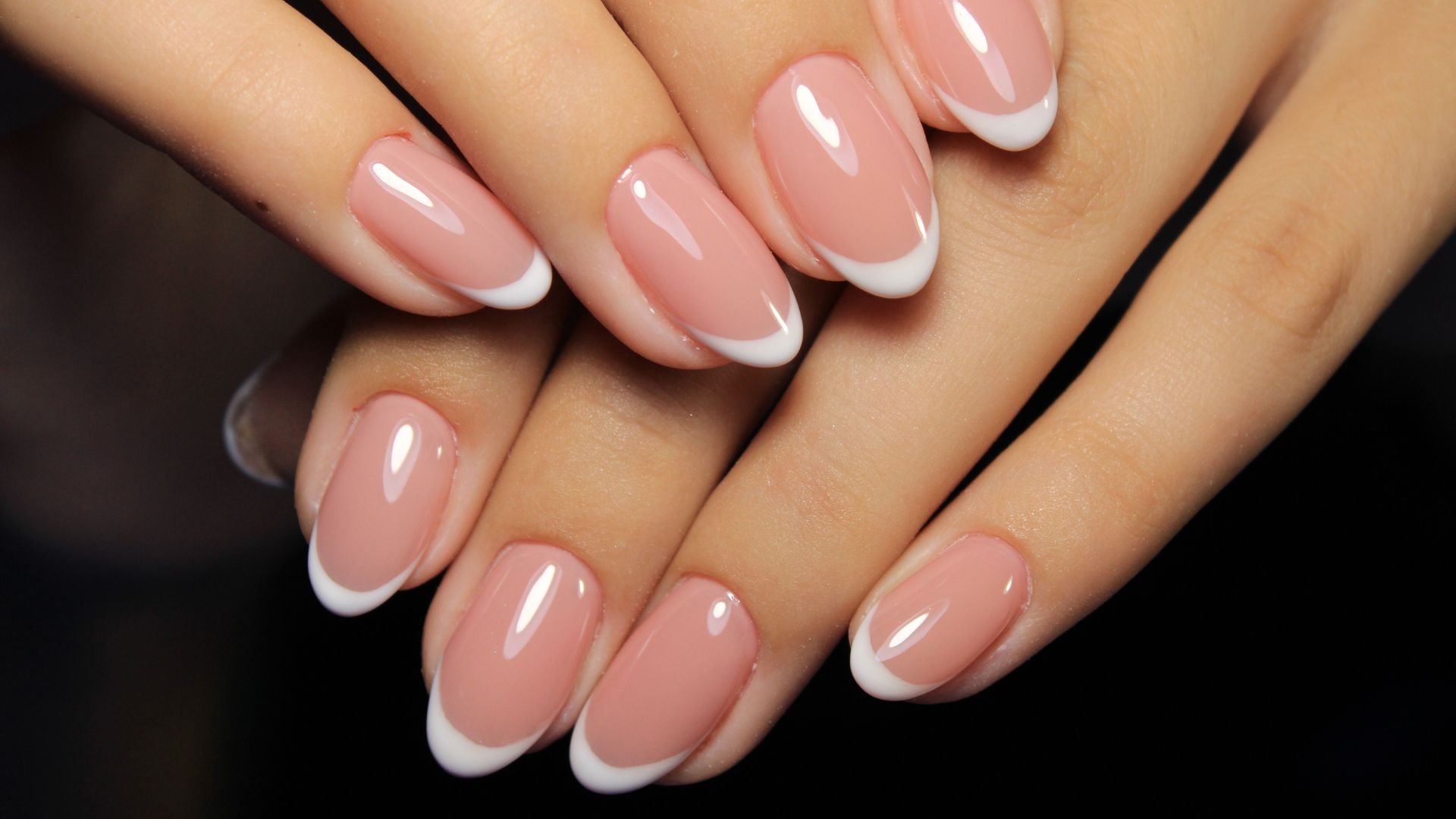 Perfectly manicured French tip nails with pink and white polish
